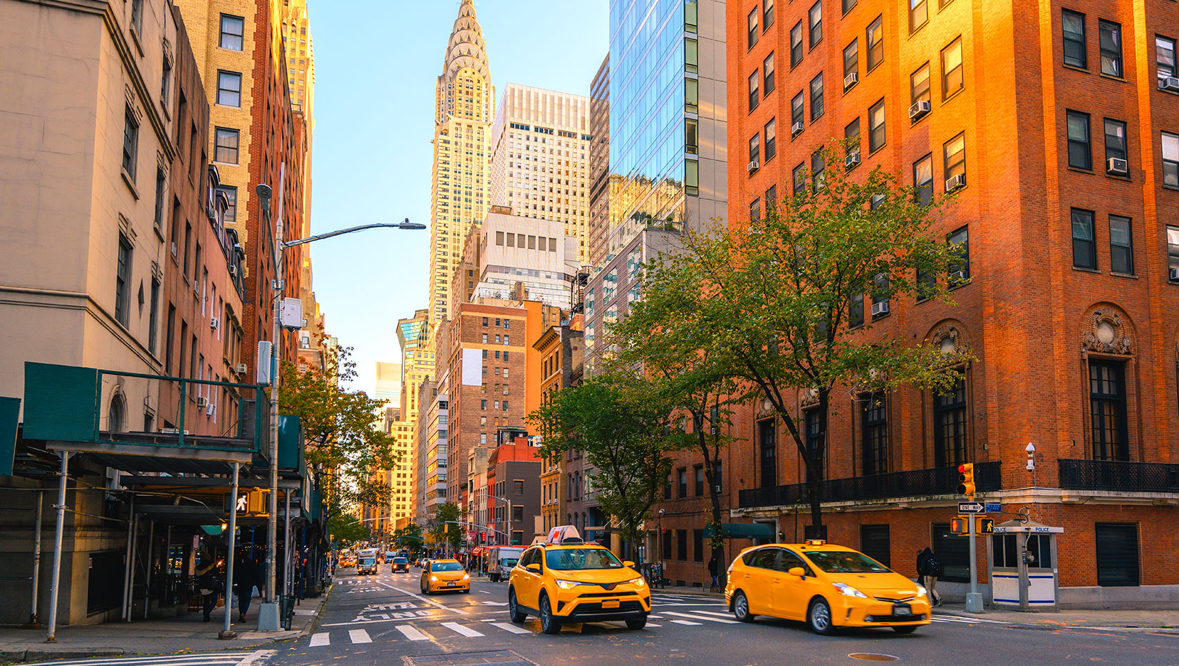 street in NYC with skyline in background