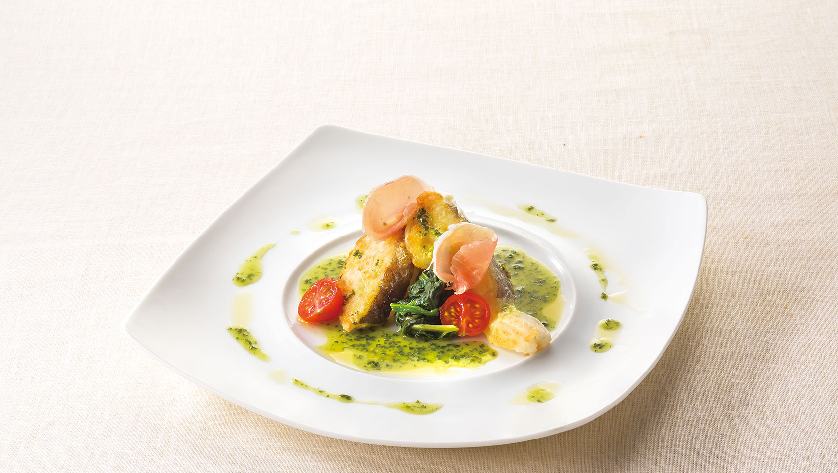 gourmet dinner plate with fish and tomatoes