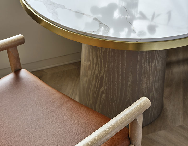 marble table and brown leather chairs